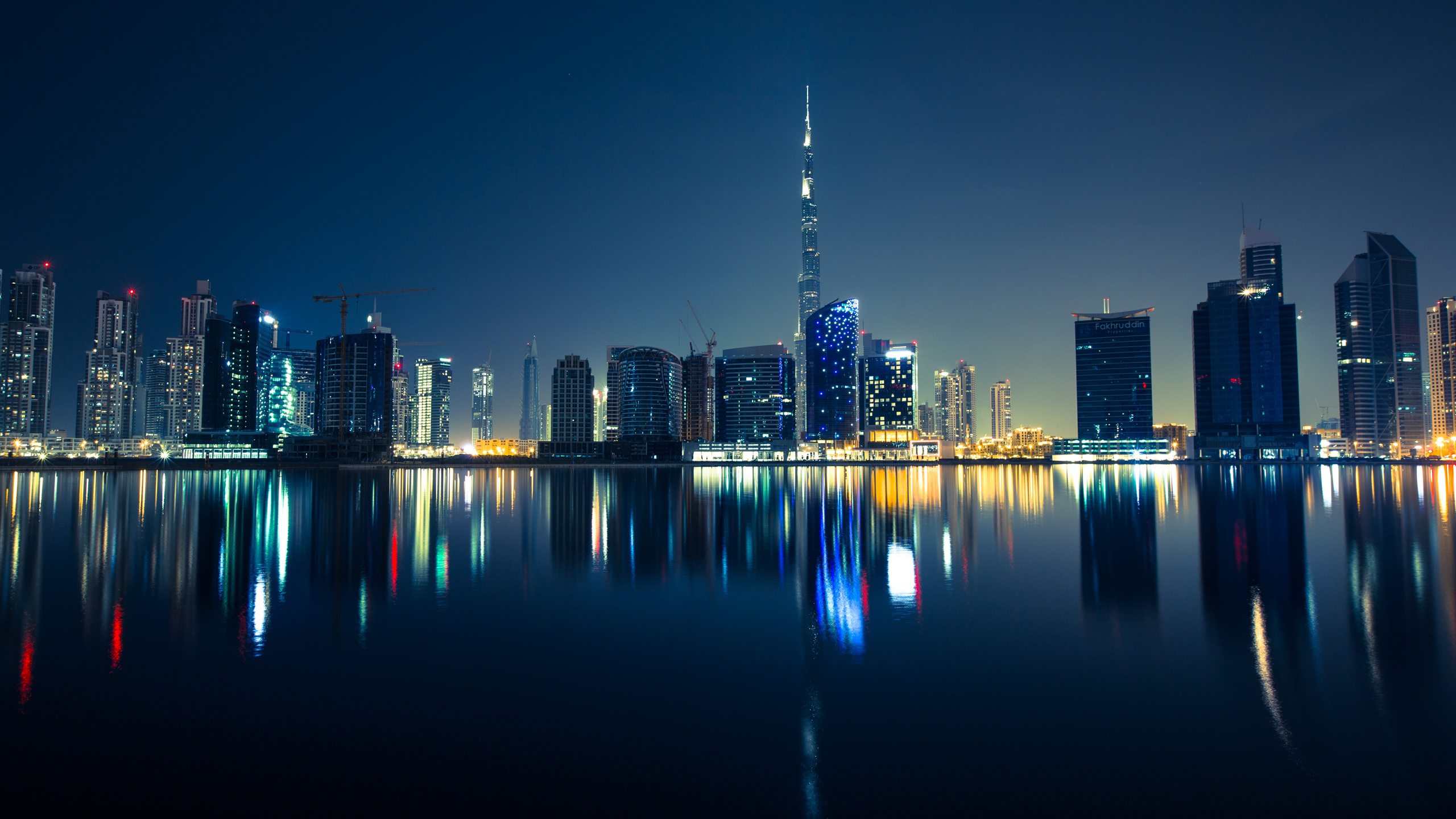 Dubai skyline and the Burj Khalifa reflected in the water at night