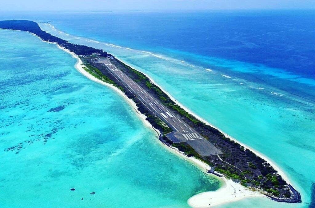 Aerial view of Agatti island's runway between two turquoise lagoons, Lakshadweep