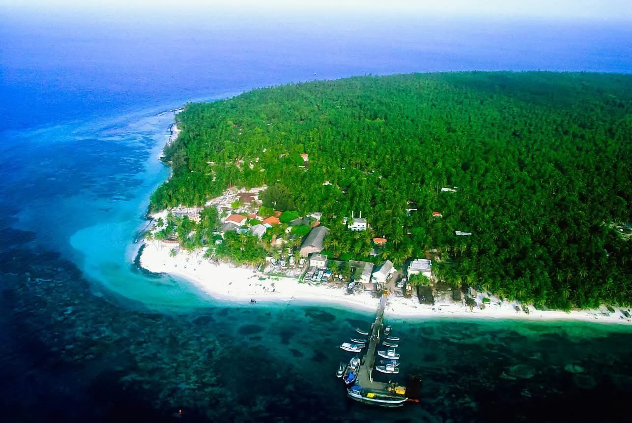 Aerial view of a Lakshadweep island's turquoise lagoon and reef