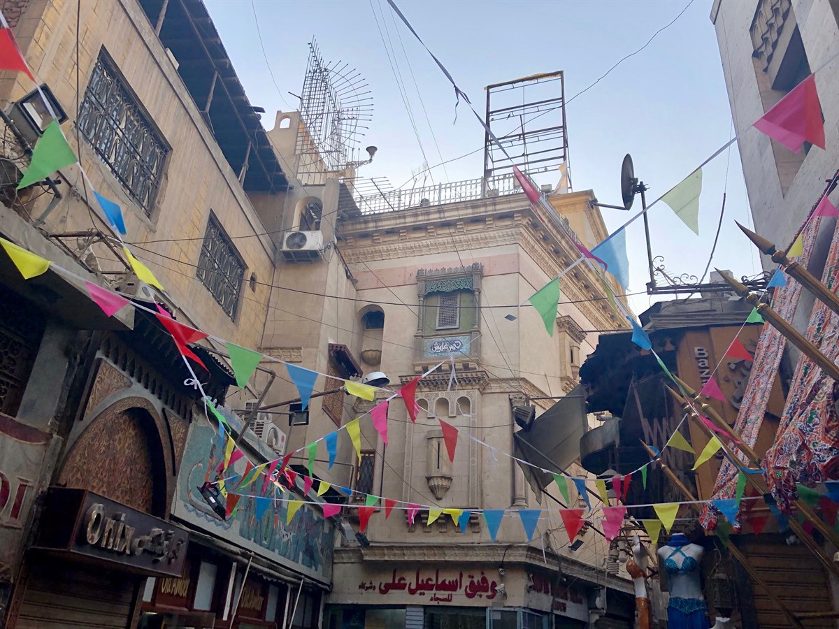 A lane of Khan el-Khalili bazaar in Islamic Cairo, strung with colourful bunting above the shopfronts