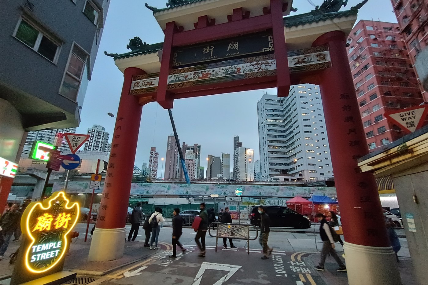 The red Temple Street arch and neon sign at dusk in Yau Ma Tei, Kowloon, Hong Kong