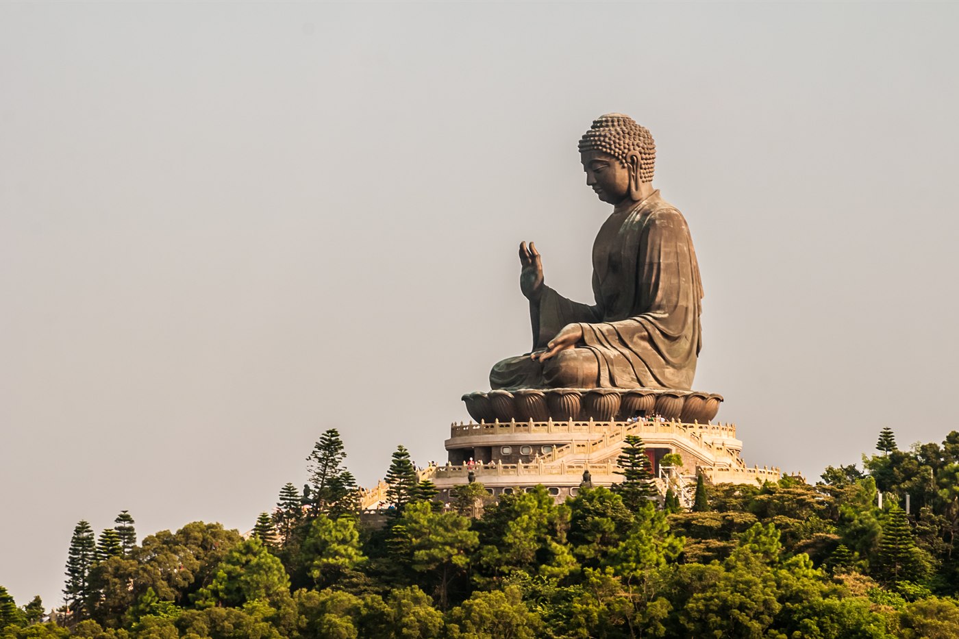 The bronze Tian Tan Buddha seated above the trees at Ngong Ping, Lantau Island, Hong Kong