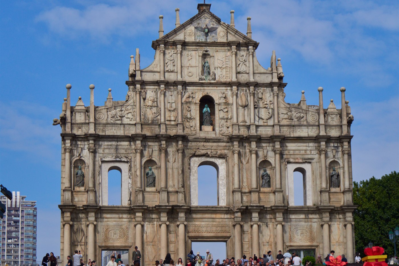 The carved stone facade of the Ruins of St Paul's under a blue sky, Macau