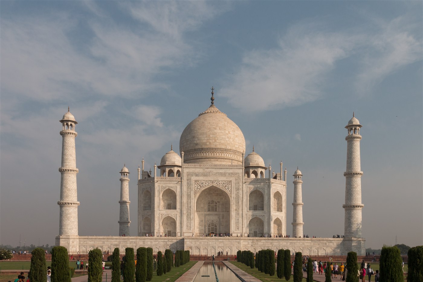 The Taj Mahal's white marble dome and minarets reflected in its long pool, Agra