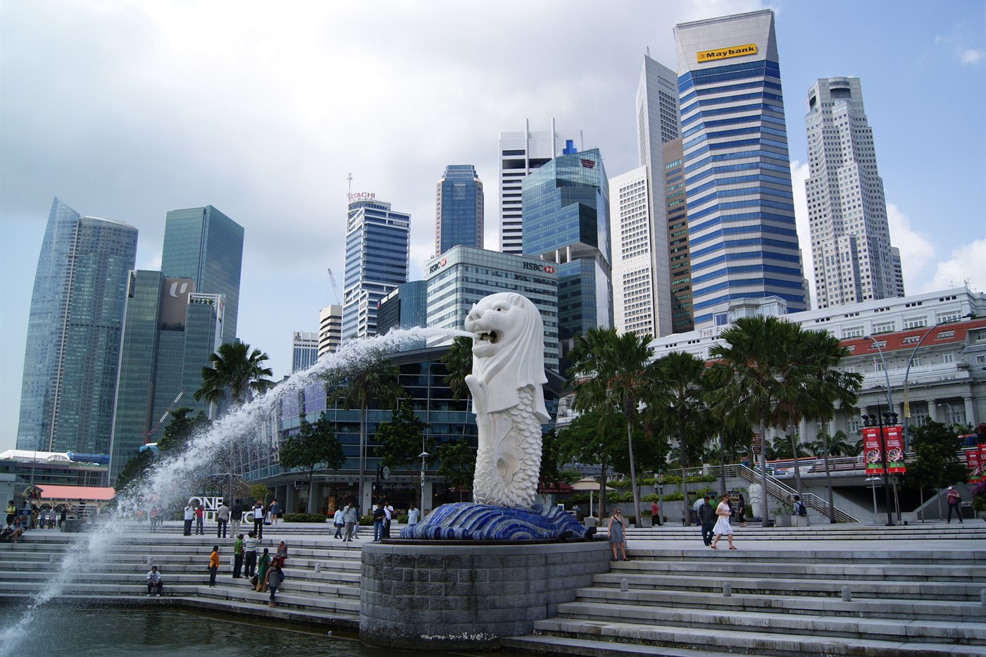 The Merlion statue spouting water into Marina Bay, with Marina Bay Sands and the Singapore skyline behind