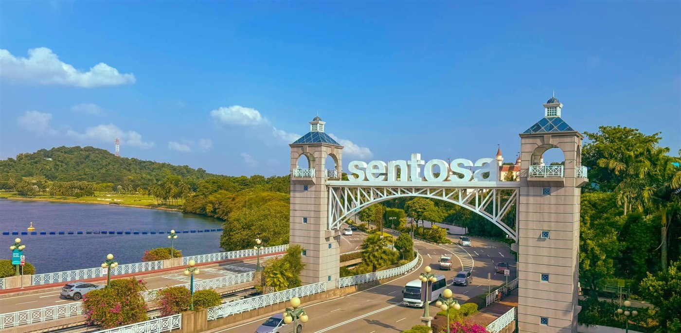 The Sentosa gateway bridge and sign above the road leading onto the resort island, Singapore