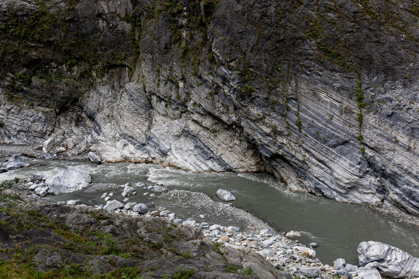 Grey marble cliffs of Taroko Gorge above the rocky bed of the Liwu River, Hualien, Taiwan