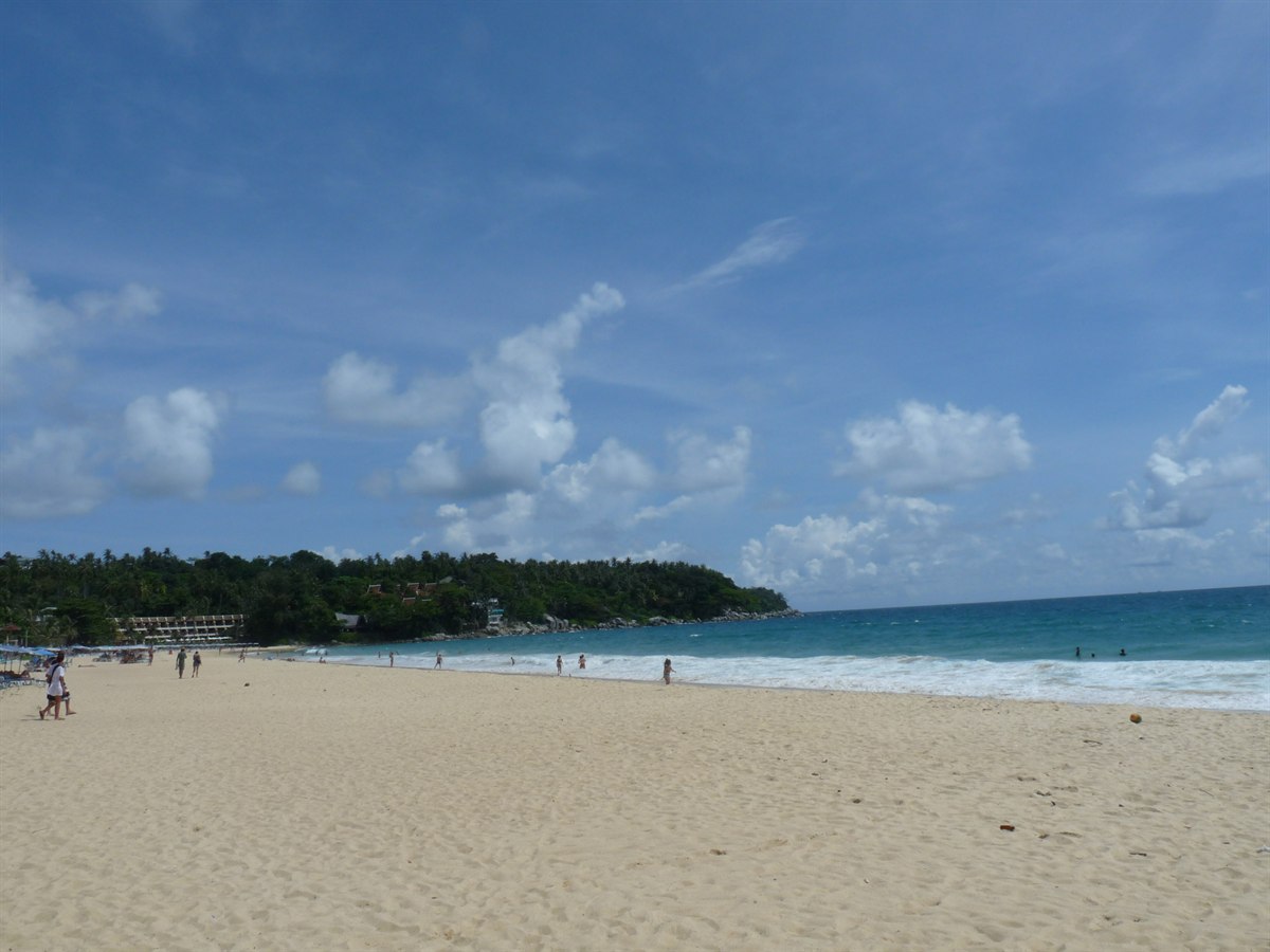 Karon Beach, Phuket, with clear turquoise water and a forested headland