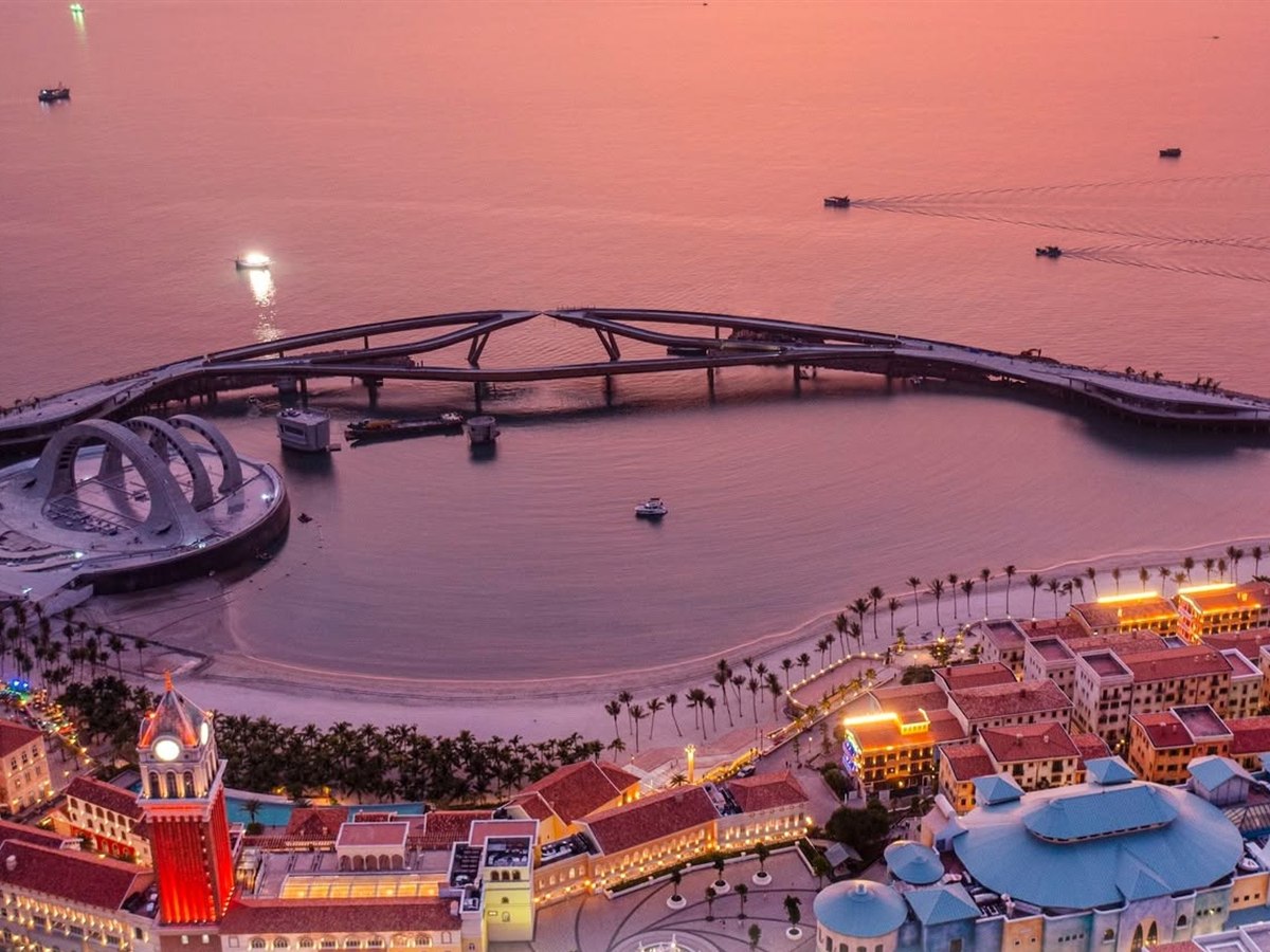 Aerial dusk view of Sunset Town's Kiss Bridge and the harbour beach on Phu Quoc Island, Vietnam