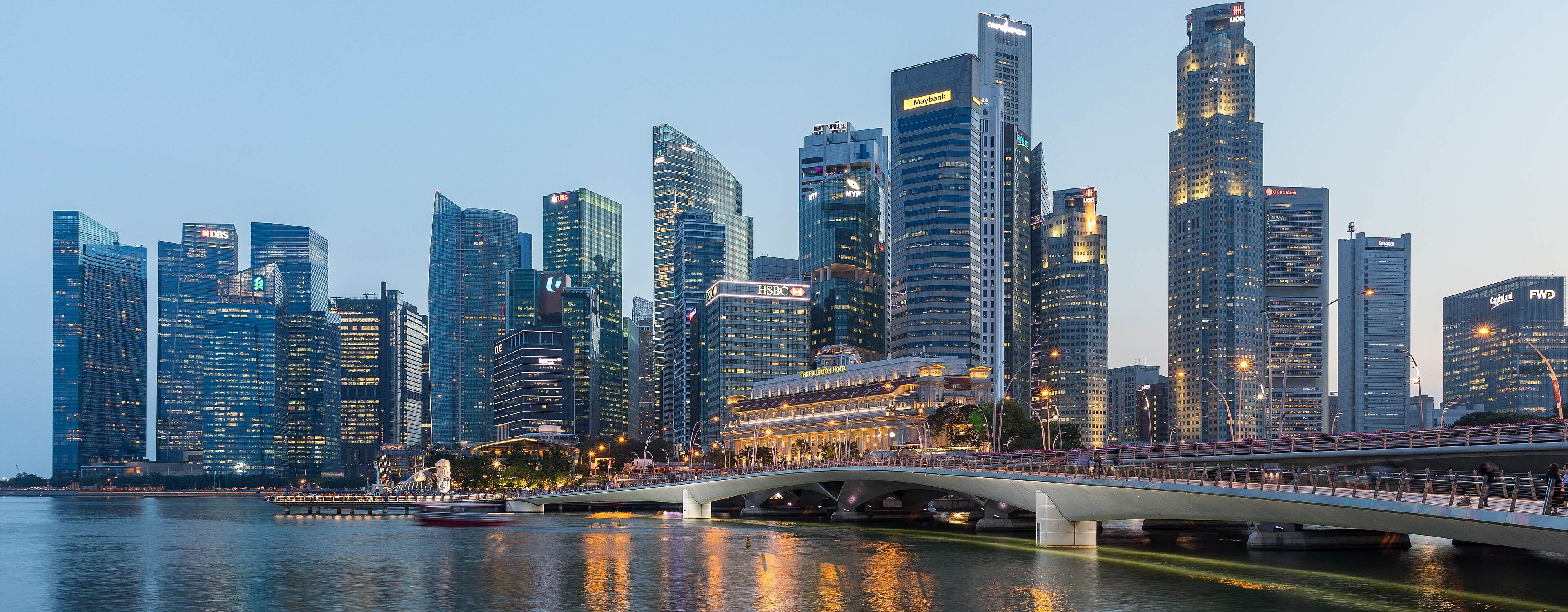 Skyscrapers of the Central Business District and the Esplanade Bridge reflected in Marina Bay at blue hour, Singapore