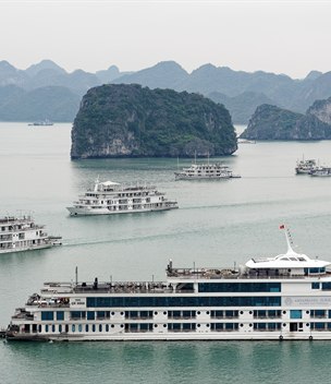 Cruise ships among limestone islands in Ha Long Bay, Vietnam